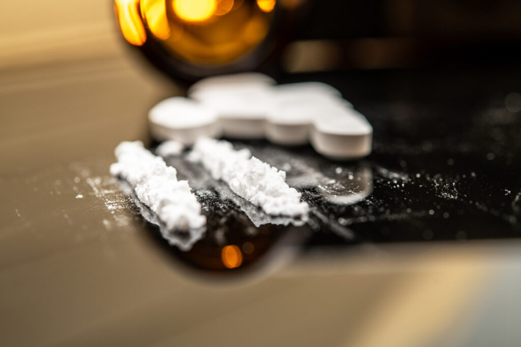 Lines of powder and pills representing angel dust and substance abuse awareness in Spokane WA