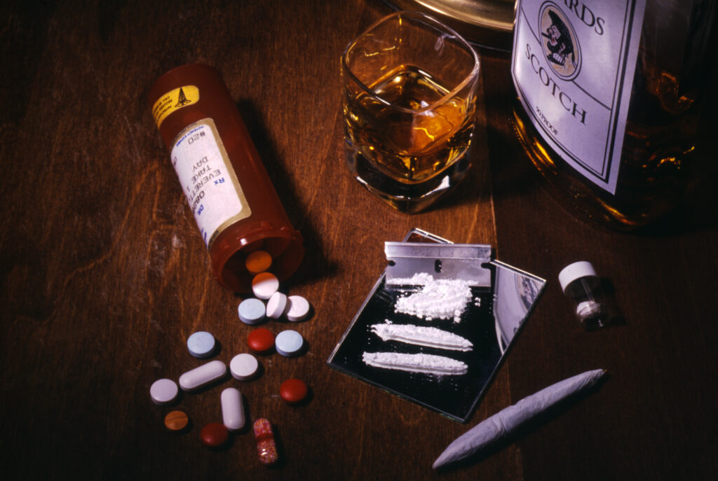 Cocaine addiction and substance abuse image showing pills, cocaine lines, alcohol, and drugs in Spokane Valley, Washington State.