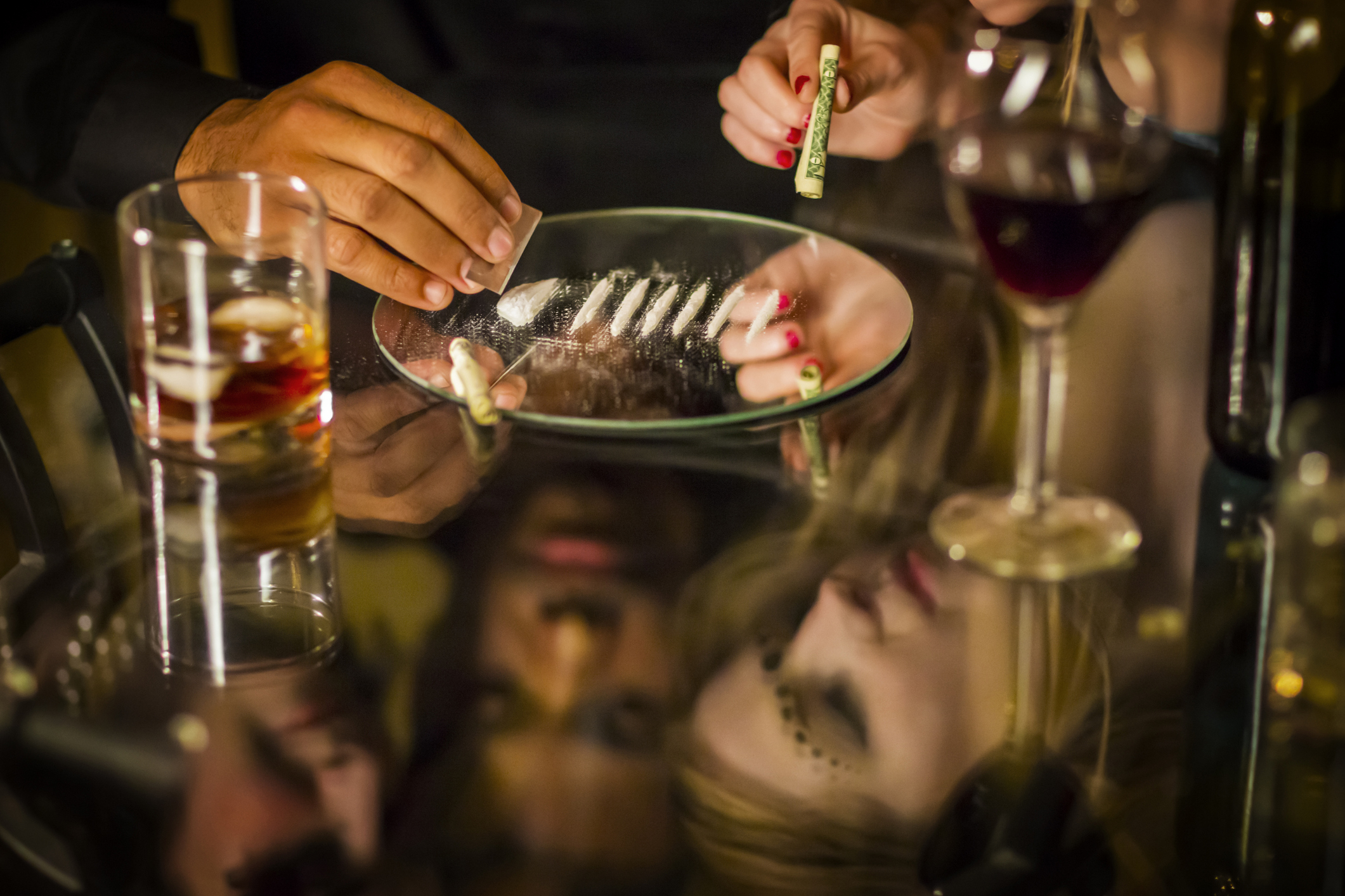 People using cocaine on a glass table illustrating the need for cocaine detox in Spokane WA
