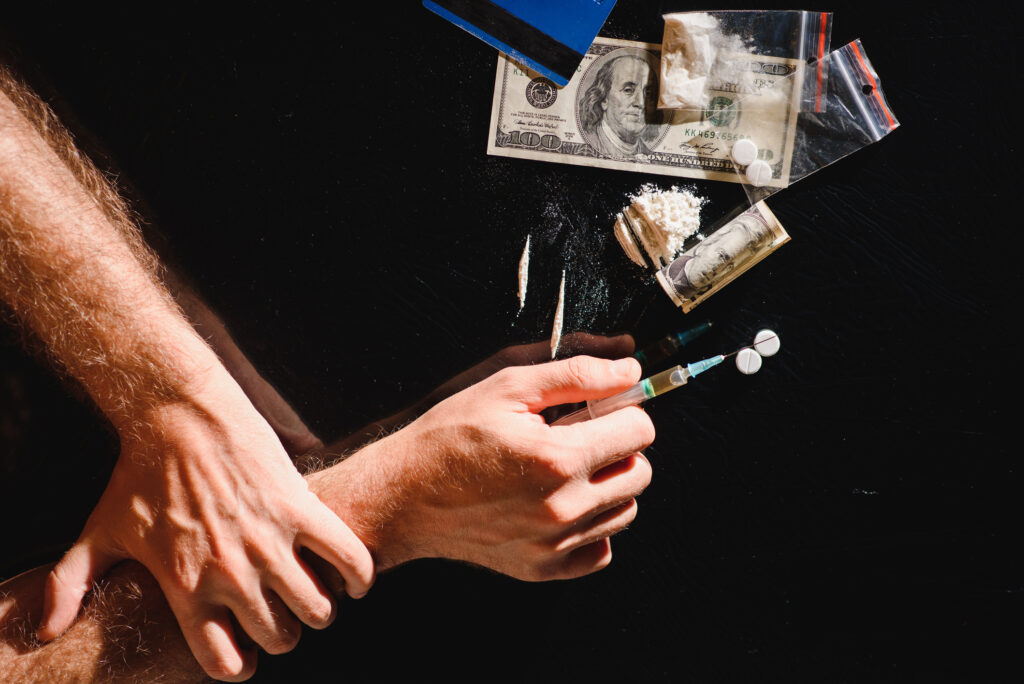 Person preparing to inject drugs showing risk of cocaine overdose in Spokane WA