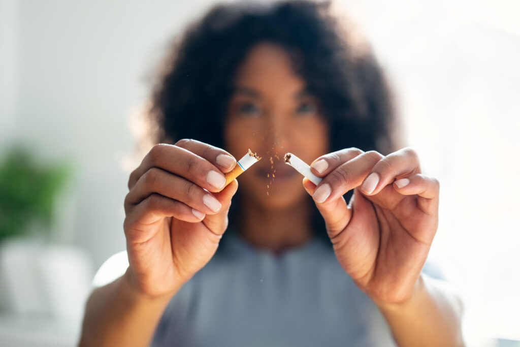 Person breaking cigarette symbolizing quitting cold turkey in Spokane WA
