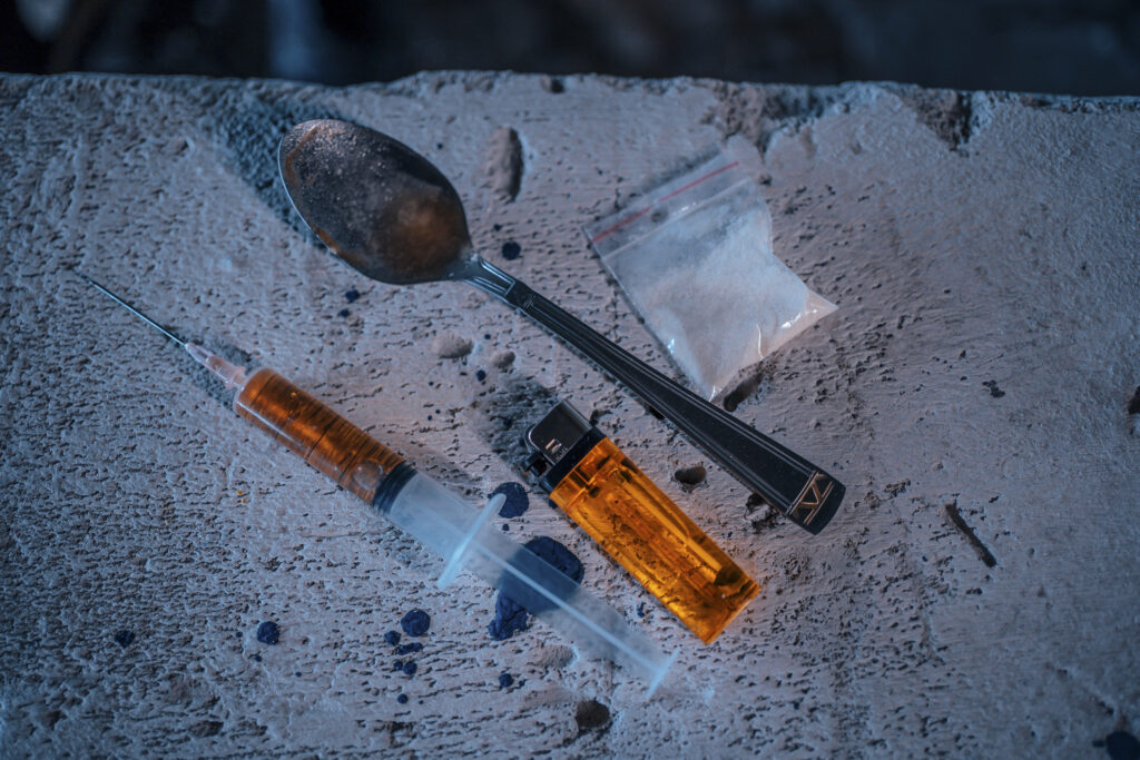 Used drug paraphernalia including syringe, spoon, lighter, and plastic bag symbolizing crack addiction in Spokane WA