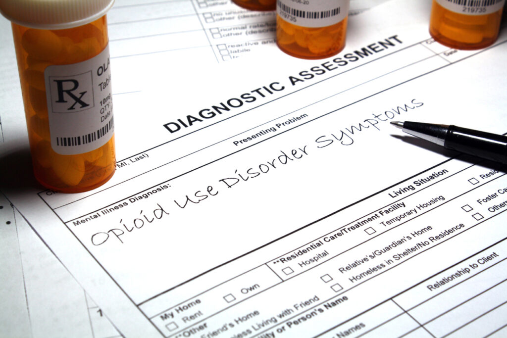 Opiate withdrawal assessment form showing opioid use disorder diagnosis with prescription pill bottles in Spokane Valley, Washington State.