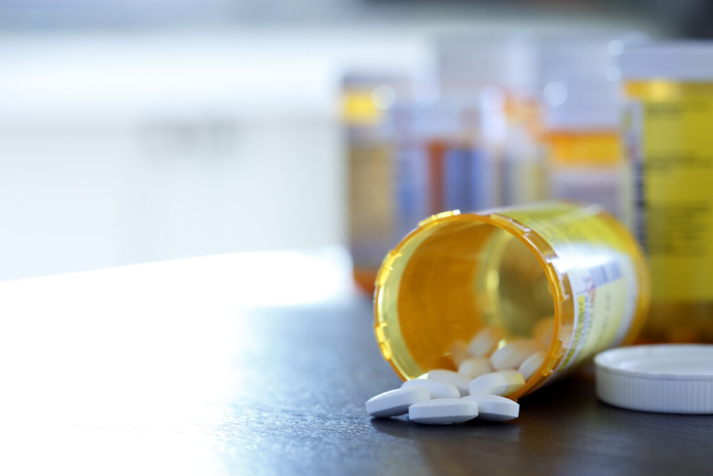 spilled prescription bottle with white tablets on counter, symbolizing prescription drug addiction in Spokane, Washington State (WA) and Spokane Valley