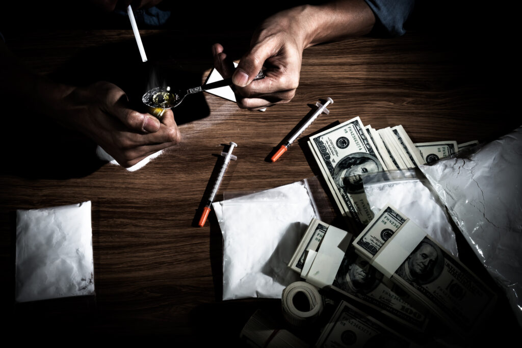 Dilaudid addiction concept with drugs, cash, and syringes representing substance abuse in Spokane WA