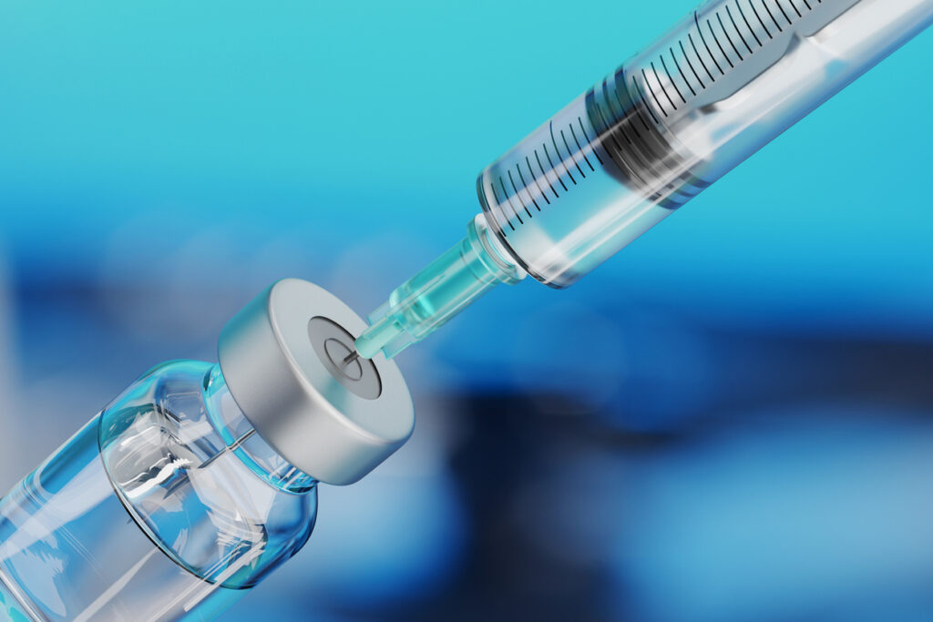 Close-up of syringe drawing medication from vial, representing vivitrol side effects in Spokane, Washington State