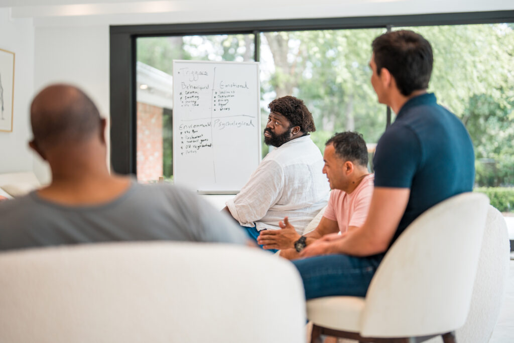 men discussing triggers and goals on a whiteboard during a group therapy meeting about what is sobriety in Spokane Valley, WA and greater Washington State