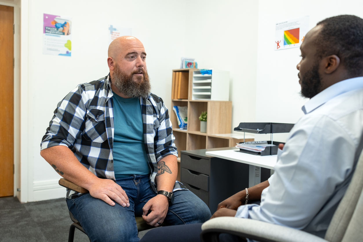Male patient talking to a therapist in a counseling office, representing Spokane mental health services in Washington State.