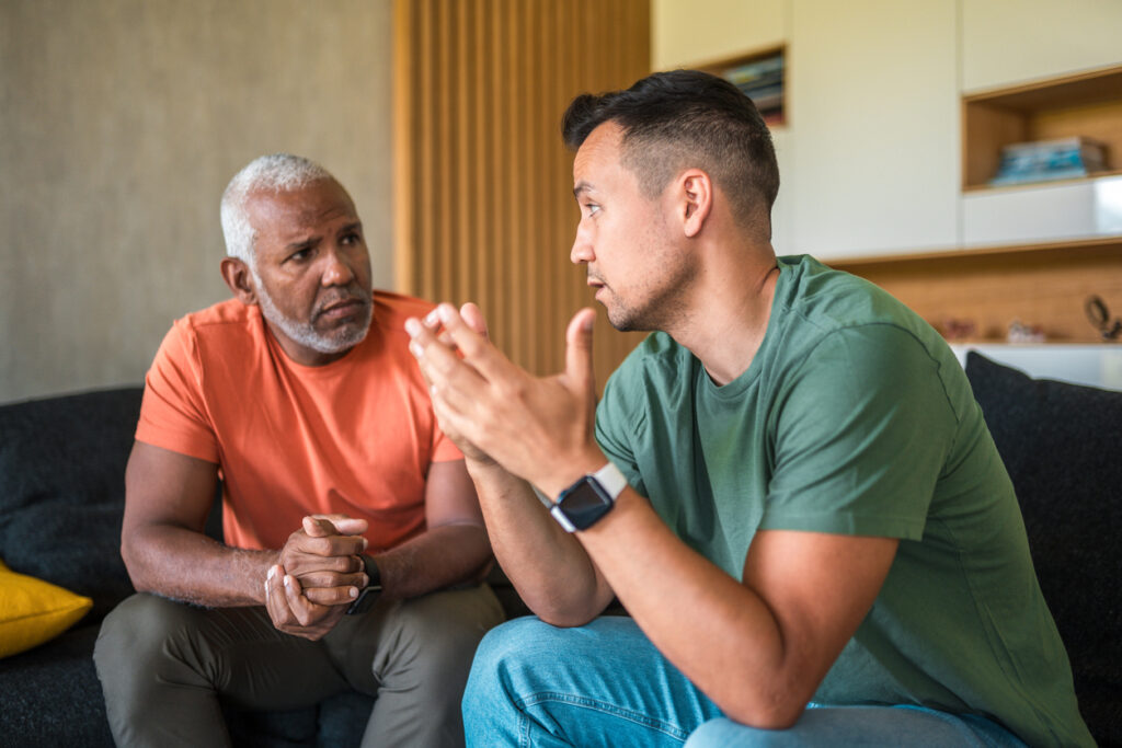Two men having a serious conversation about mental health awareness during Men’s Mental Health Month in Spokane WA