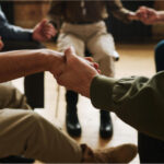 People holding hands representing mental health support groups after treatment in Washington