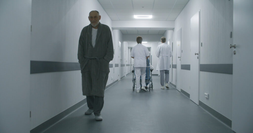 Elderly patient walking in psychiatric hospital corridor how to admit yourself to a mental hospital in Spokane, WA