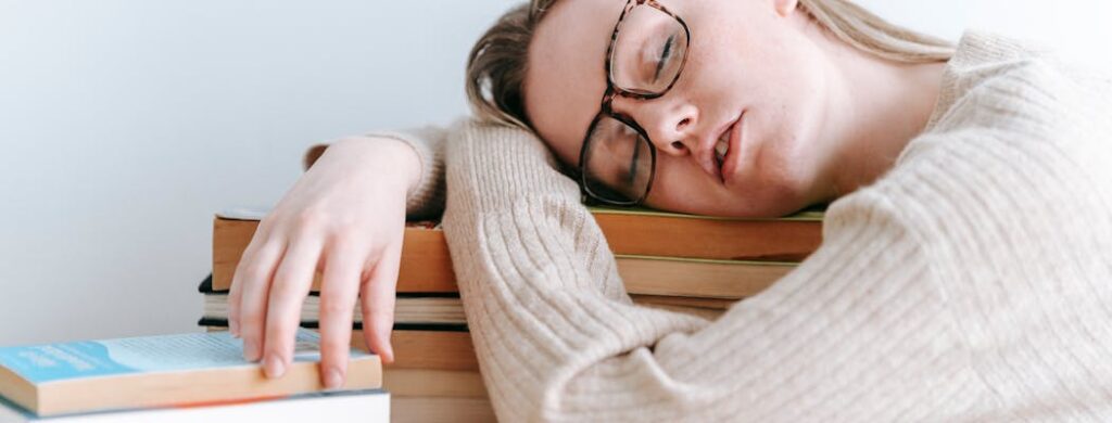 A person sleeping on books