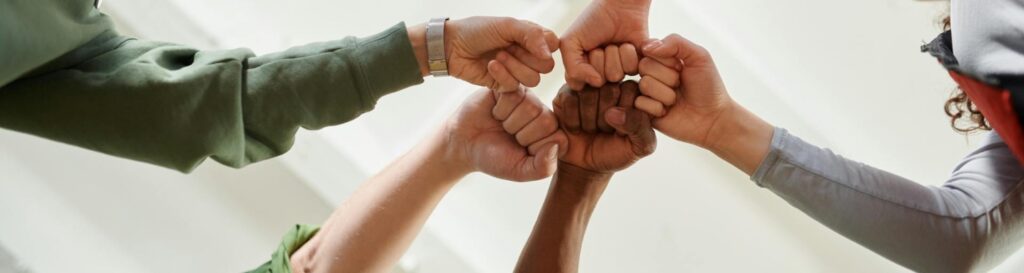 A group of people doing a fist bump