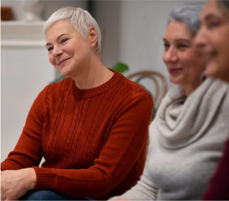 Older women smiling and engaging in a supportive aging and mental health discussion group in Spokane WA