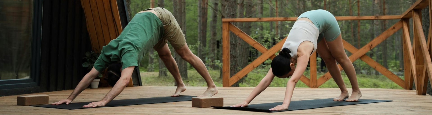 a couple stretching in the forest 