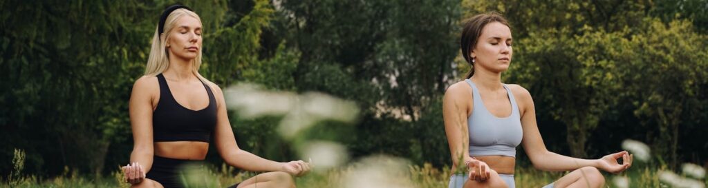 Two people meditating in nature as a form of anxiety treatment spokane wa