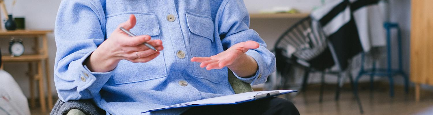 A psychotherapist holding a pen.