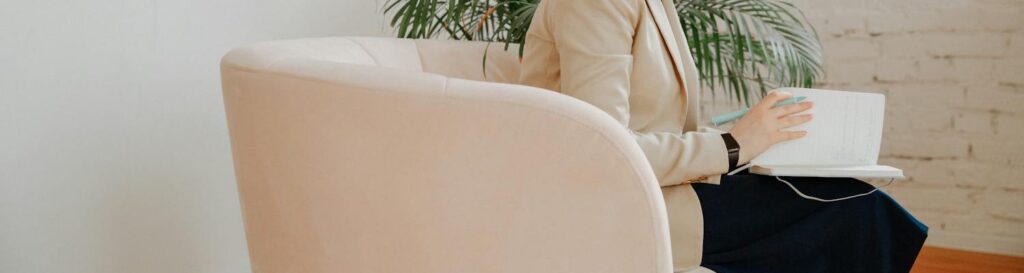 A therapist taking notes during a DBT session