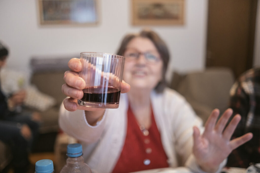 an older woman raising a glass of wine spokane valley washington