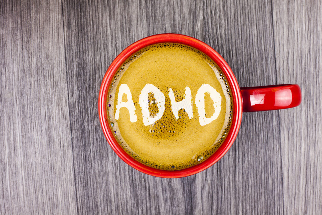 Coffee cup with ADHD letters symbolizing caffeine and ADHD connection in Spokane WA