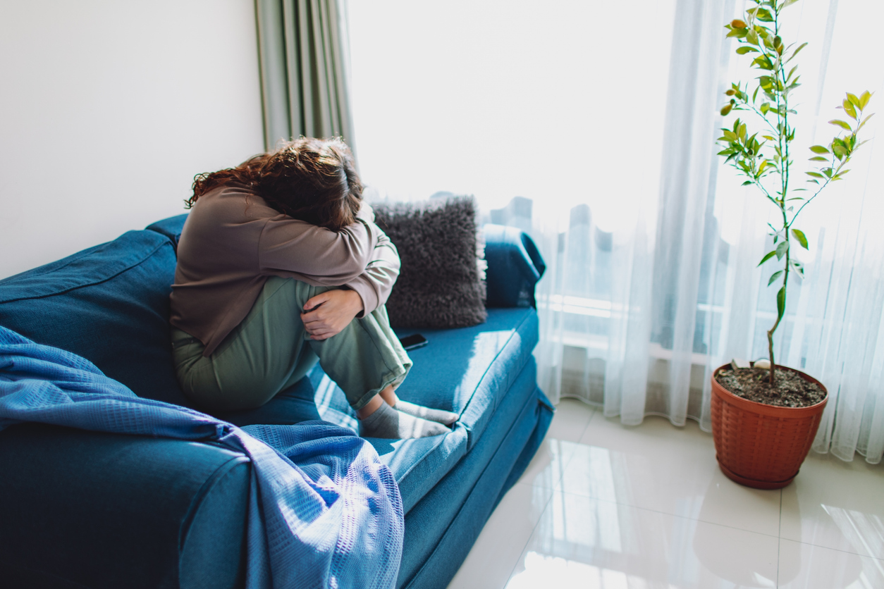 person sitting on a couch crying spokane valley washington