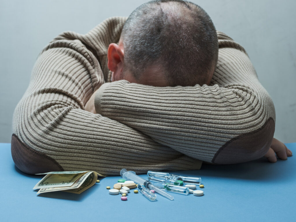 man with schizophrenia and addiction issues upset sad withdrawn